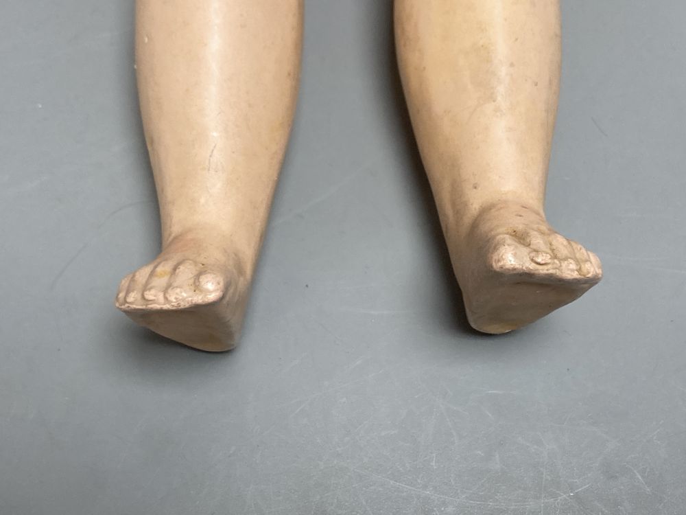 An Armand Marseille bisque boy doll, mould 990 with fixed glass eyes, 30cm, a bisque doll with jointed composition body, 47cm and a pai